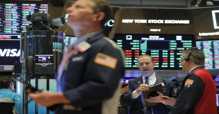 Traders work on the floor of the NYSE in New York