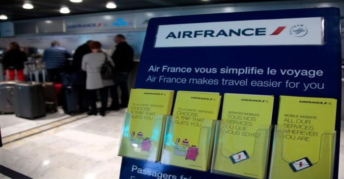 Passengers line up at an Air France counter at Nice International Airport in Nice