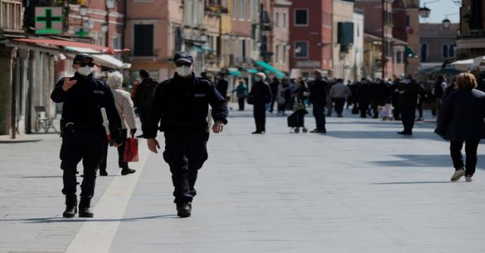 FILE PHOTO: Police officers walk on the streets of Venice as Italy's lockdown measures continue