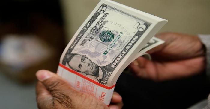 A packet  of Lincoln five dollar bills is inspected at the Bureau of Engraving and Printing in