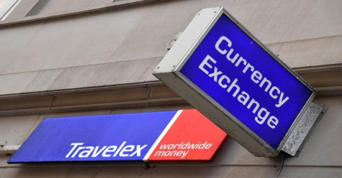 Signage is seen on a branch of Travelex Currency Exchange in London