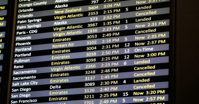 FILE PHOTO: Several canceled flights are pictured on a monitor at Seattle-Tacoma International