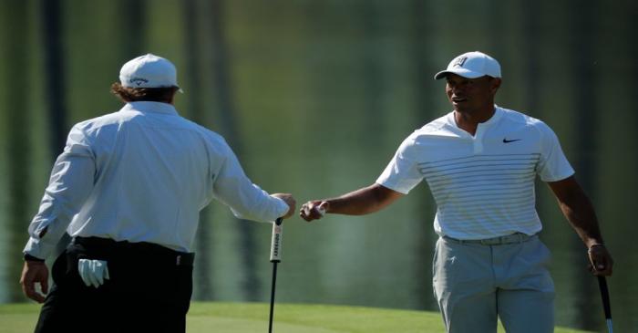 U.S. golfers Woods and Mickelson talk on the 16th green during practice for the 2018 Masters