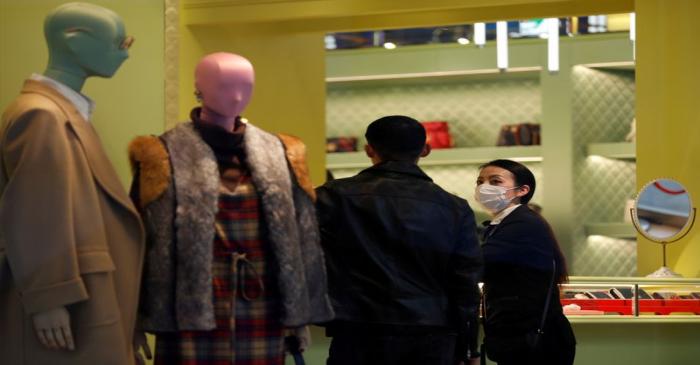 FILE PHOTO: A shop assistance wearing a protective face mask following an outbreak of the