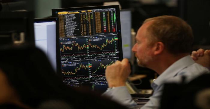 An investment manager, in the office of Aberdeen Standard Investments, watches his screen as