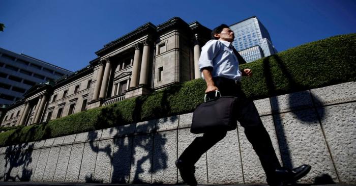 FILE PHOTO: A man runs past the Bank of Japan building in Tokyo