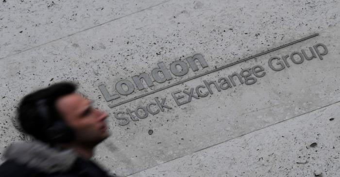 People walk past the London Stock Exchange Group offices in the City of London, Britain