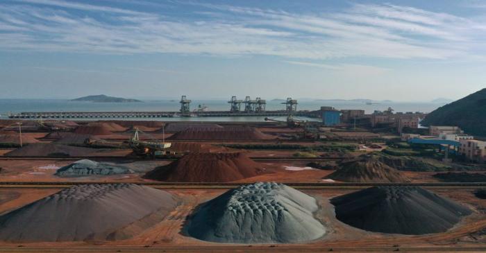 FILE PHOTO: Piles of imported iron ore are seen at a port in Zhoushan, Zhejiang