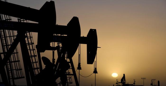 FILE PHOTO: Pump jacks operate at sunset in Midland, Texas