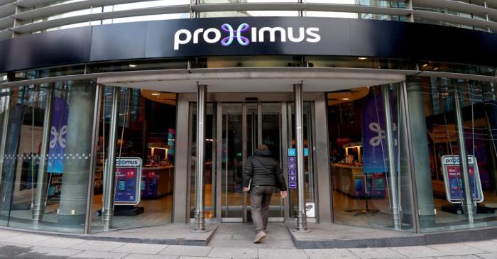 FILE PHOTO: A customer enters the headquarters of Belgian telecoms operator Proximus in