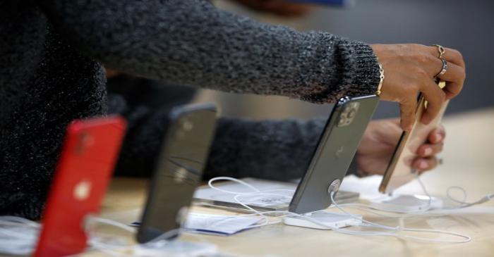 A shopper holds a cell phone during the shopping season, 'El Buen Fin' (The Good Weekend), at a