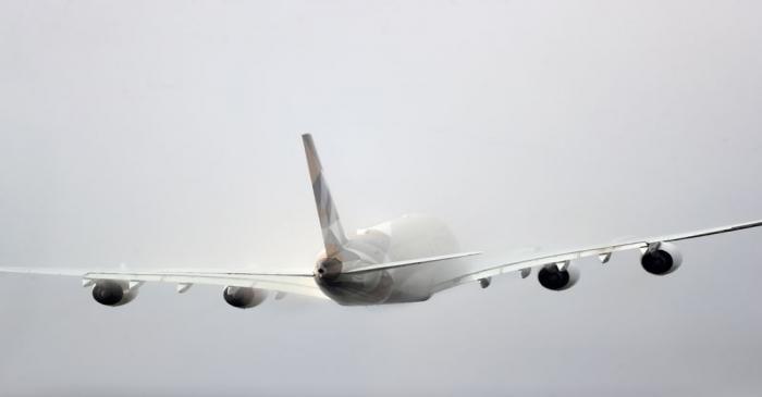 FILE PHOTO: Etihad aircraft disappears into the clouds as it takes off from Heathrow Airport in