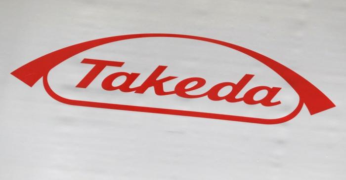 FILE PHOTO: The logo of Takeda Pharmaceutical Co. is displayed at the company's news conference