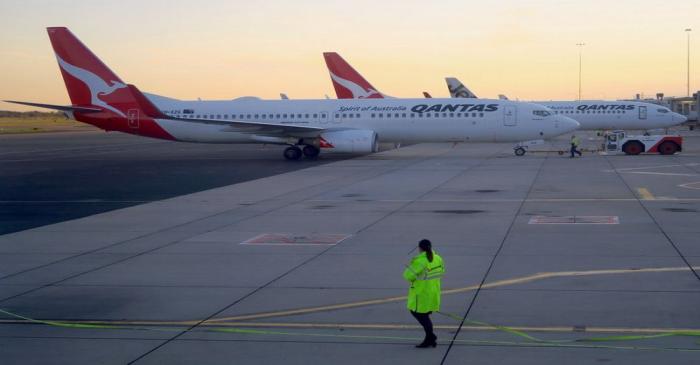 FILE PHOTO: Workers are seen near Qantas Airways, Australia's national carrier, Boeing 737-800