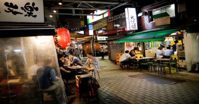 FILE PHOTO: People enjoy drinks and dinner at a Japanese izakaya pub, as the spread of the