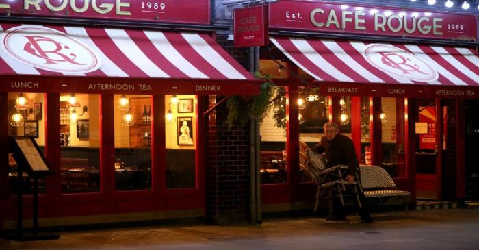 FILE PHOTO: A worker packs away tables and chairs at a Cafe Rouge restaurant as the number of