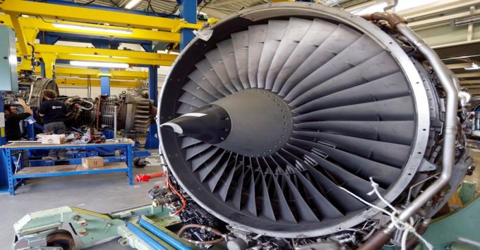 Employees do maintenance tasks on an Airbus A320 engine in the recycling and storage yard at