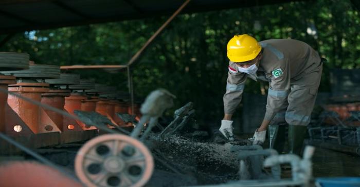 A worker adjusts machinery used to extract lead and zinc from ore at a smelter owned by Lumbung