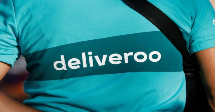 A biker, wearing a Deliveroo t-shirt, demonstrates during a call on clients to boycott the