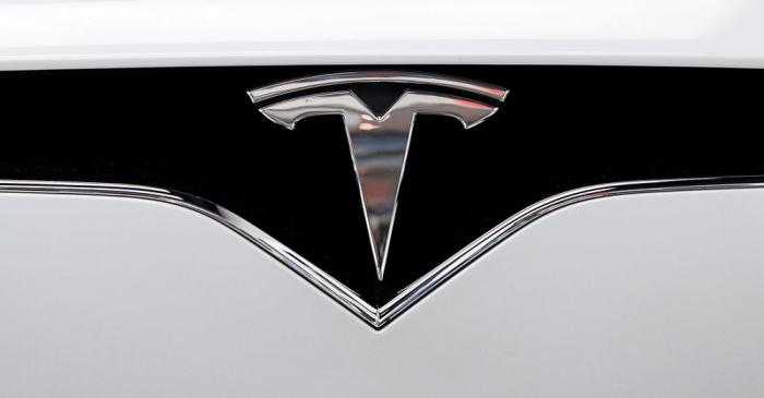 FILE PHOTO: The Tesla logo is seen on a car at Tesla's showroom in Manhattan's Meatpacking