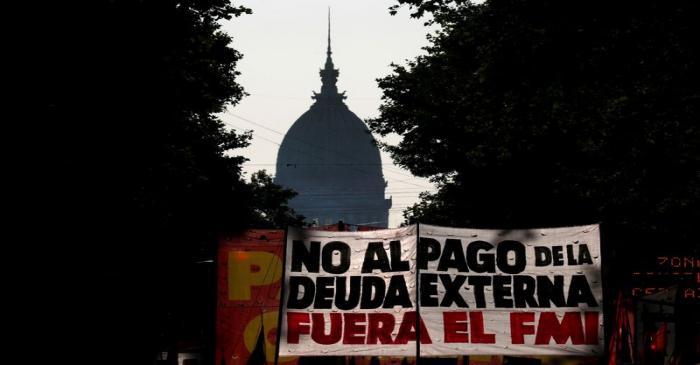 FILE PHOTO: Demonstrators hold a placard that reads 