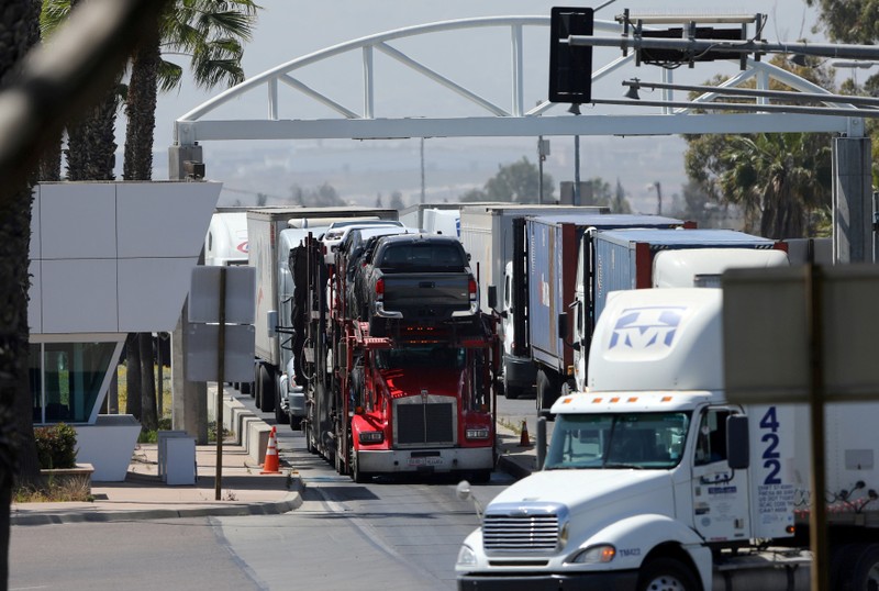 FILE PHOTO: A transport truck hauls new Toyota trucks into the United States from Mexico