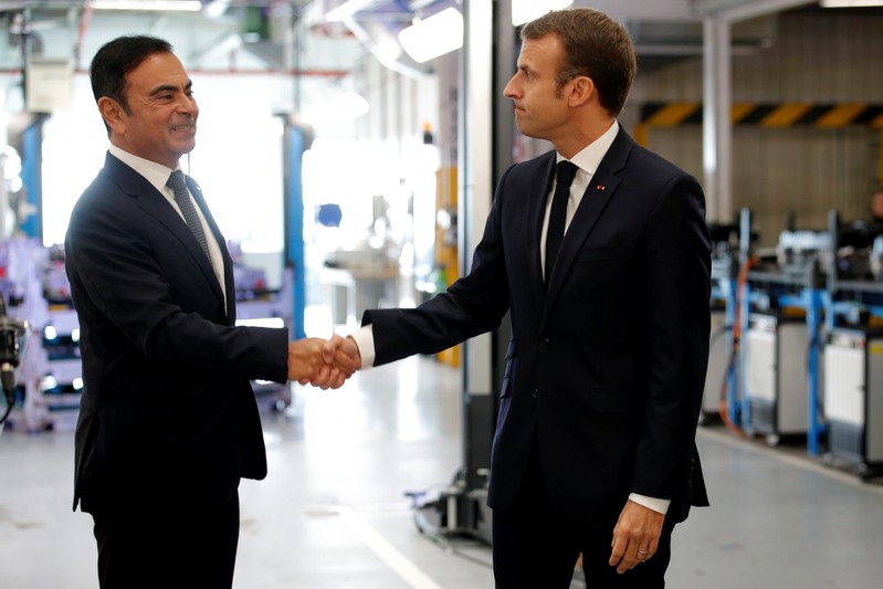 French President Emmanuel Macron skahes hands with Carlos Ghosn, CEO of French car maker