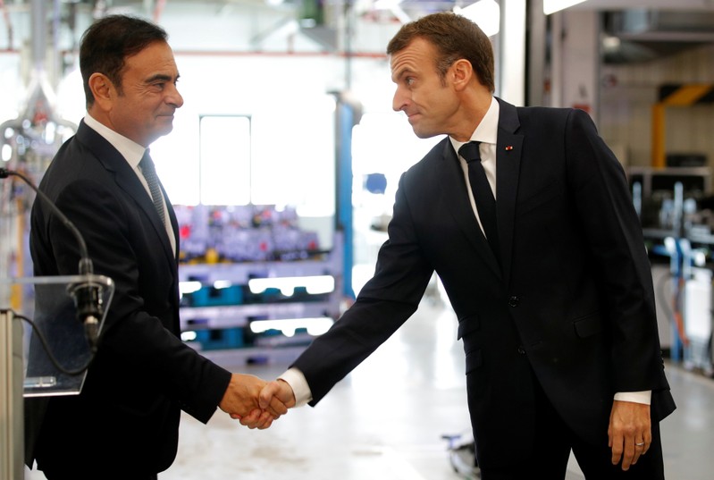 French President Emmanuel Macron skahes hands with Carlos Ghosn, CEO of French car maker