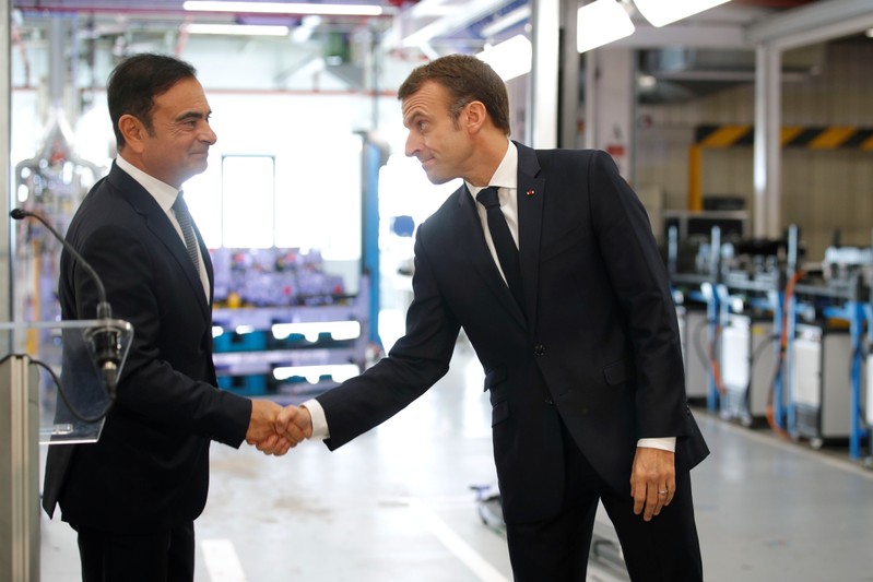 French President Emmanuel Macron skahes hands with Carlos Ghosn, CEO of French car maker