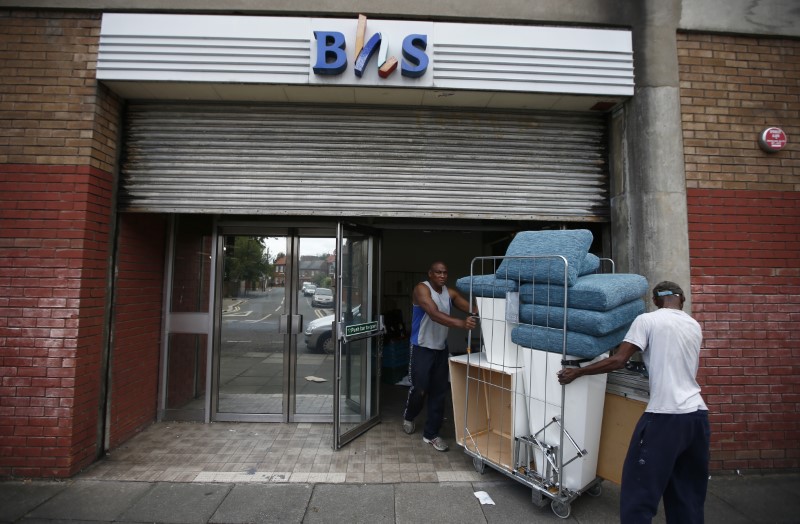 Workers remove items from the Wood Green branch of department store chain BHS after its final