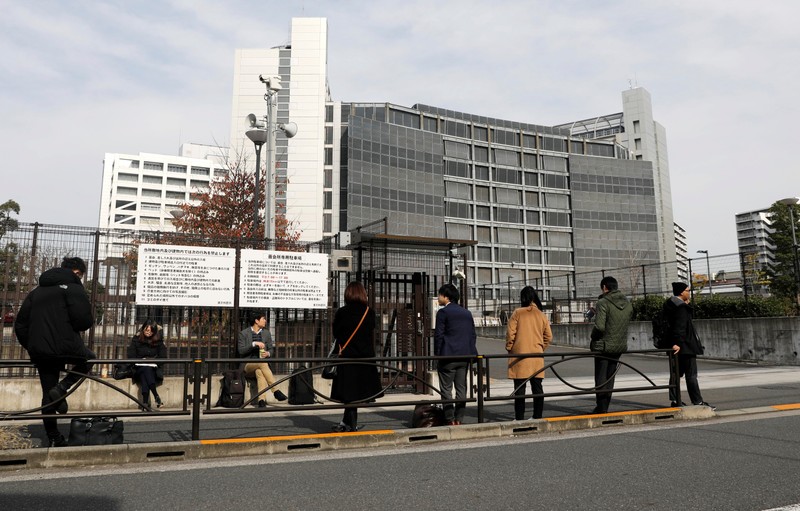 Journalists stand in front of Tokyo Detention Center in Japan