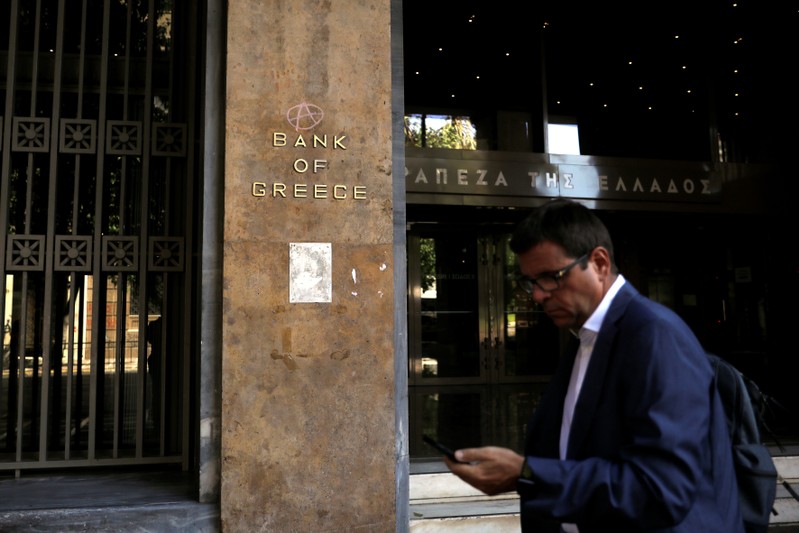 FILE PHOTO:  A man walks past the Bank of Greece headquarters in Athens