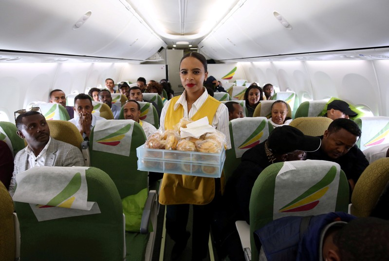 FILE PHOTO: Flight attendant serves passengers with breakfast inside Ethiopian Airlines ET314