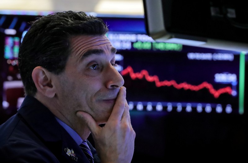 FILE PHOTO: Traders work on the floor of the NYSE in New York