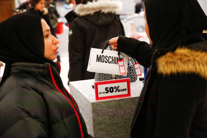 Shoppers view handbags inside the Selfridges store on Oxford Street during the Boxing Day sales