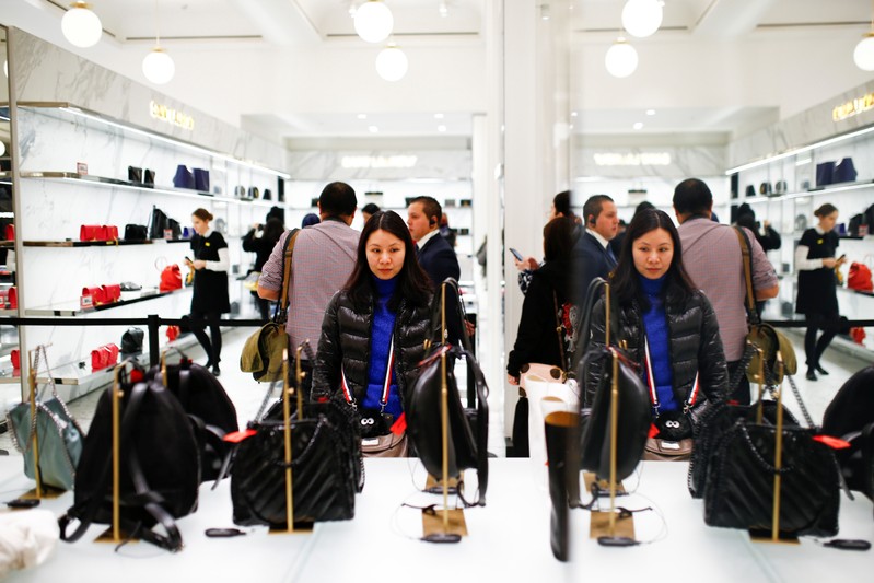 Shoppers view handbags inside the Selfridges store on Oxford Street during the Boxing Day sales