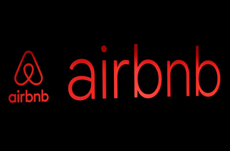 The logos of Airbnb are displayed at an Airbnb event in Tokyo