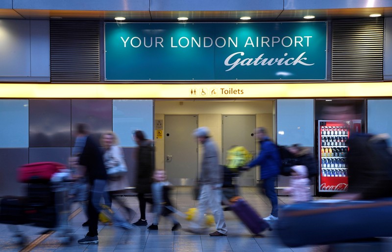 Passengers walk through the South Terminal building at Gatwick Airport, after the airport