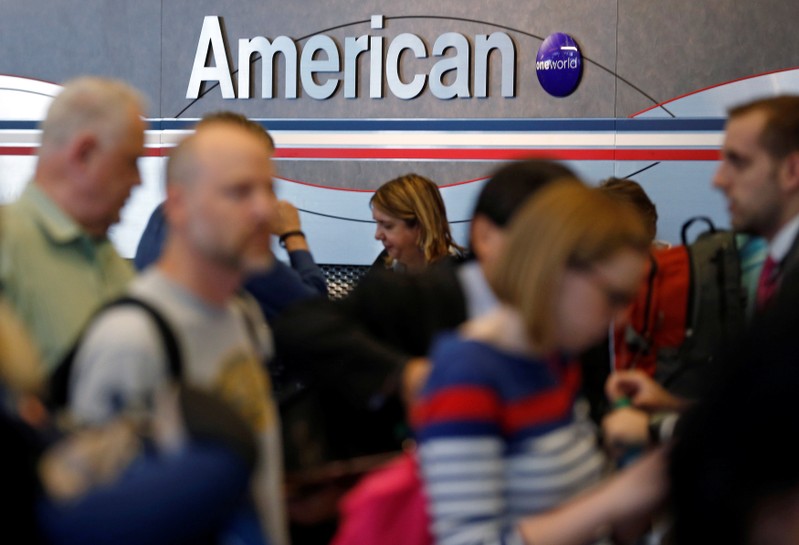 Travelers line up at an American Airlines ticket counter at O'Hare Airport in Chicago