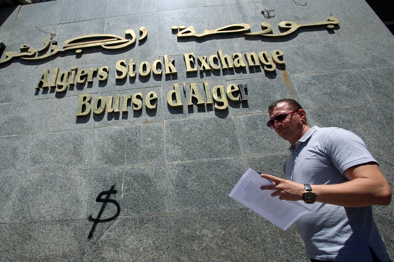 A man walks past Algiers Stock Exchange