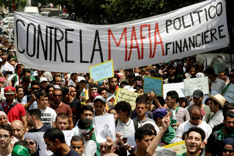 Demonstrators carry banners during an anti-government protest in Algiers