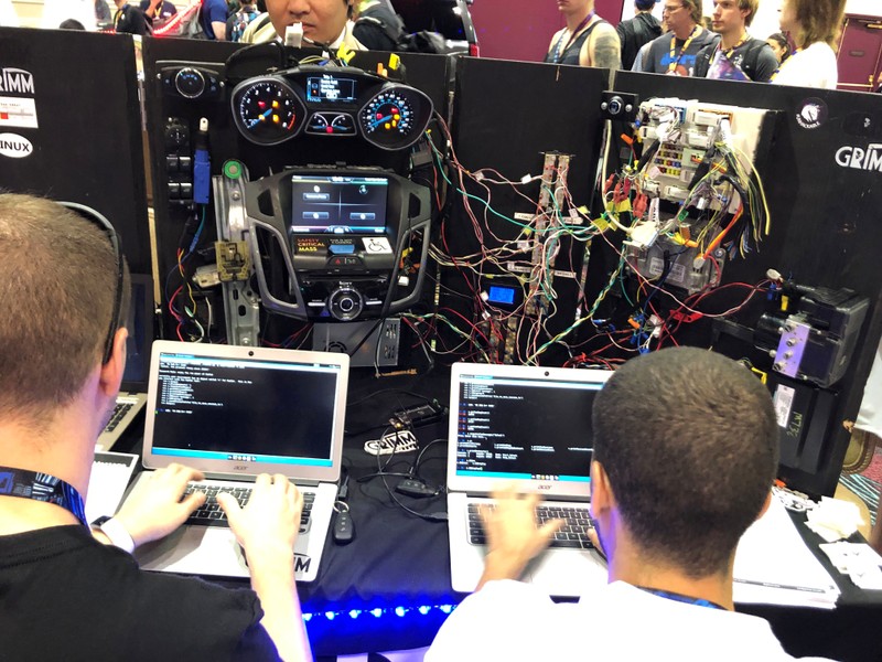 Attendees of the 2019 DEF CON cybersecurity event are seen at the conference's car hacking