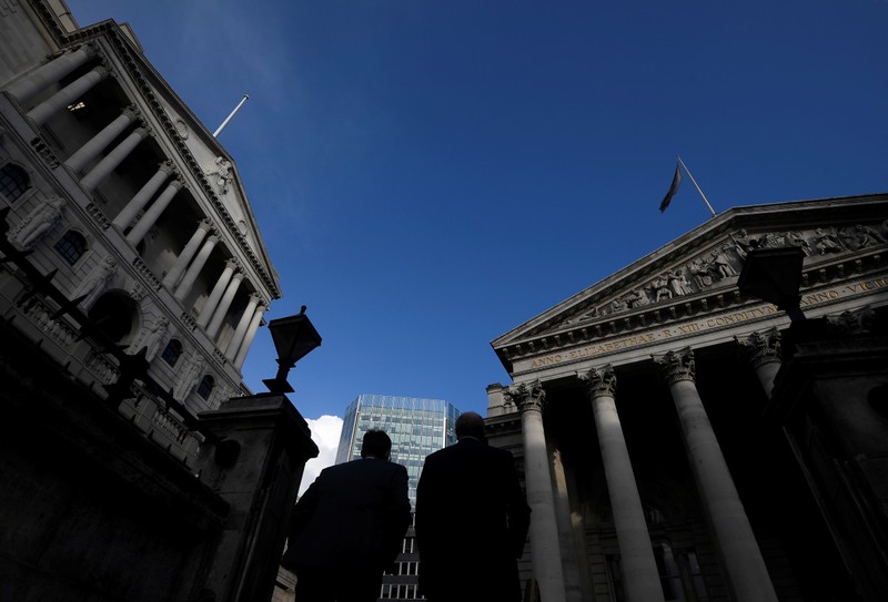 Workers emerge from Bank underground station with the Bank of England and Royal Exchange