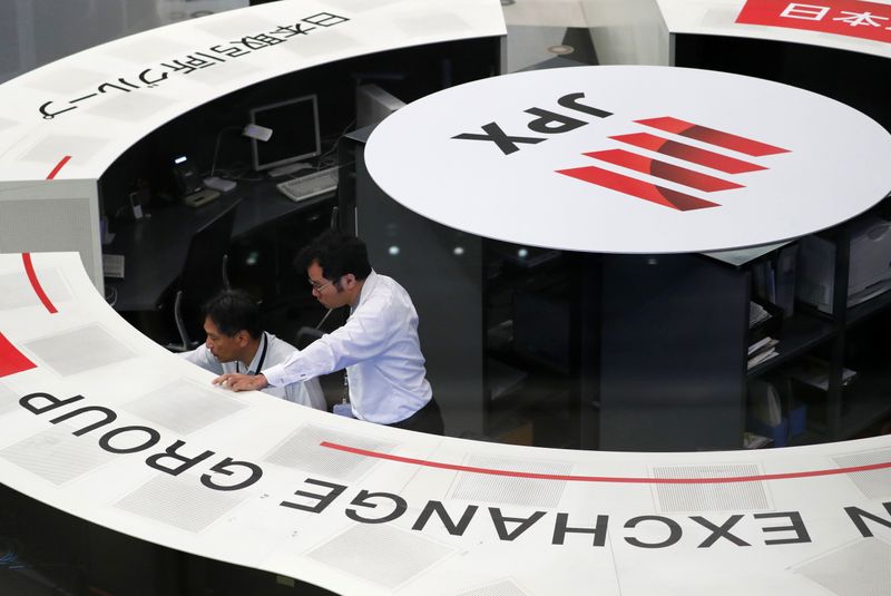 Employees of the Tokyo Stock Exchange work at the bourse in Tokyo