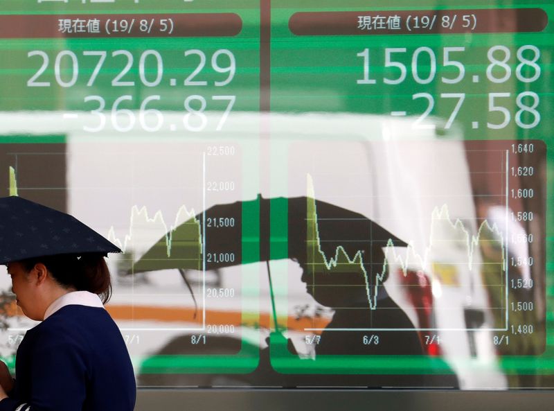 A financial trader works at their desk at CMC Markets in the City of London