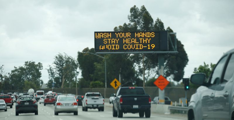 FILE PHOTO: A highway sign usually used for traffic reports advises drivers during the global