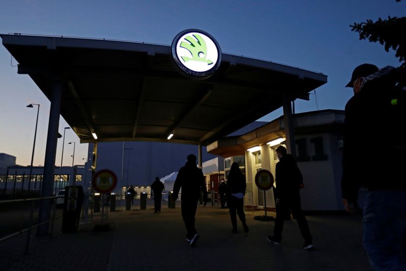 A man gets his temperature taken at Skoda Auto's factory as employees return to work after the