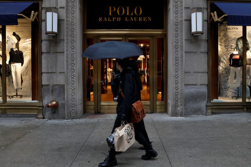 People walk past Ralph Lauren Corp.'s  flagship Polo store on Fifth Avenue in New York