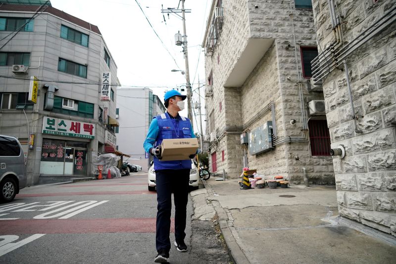 FILE PHOTO: A delivery man for Coupang Jung Im-hong wearing a mask to prevent contracting the