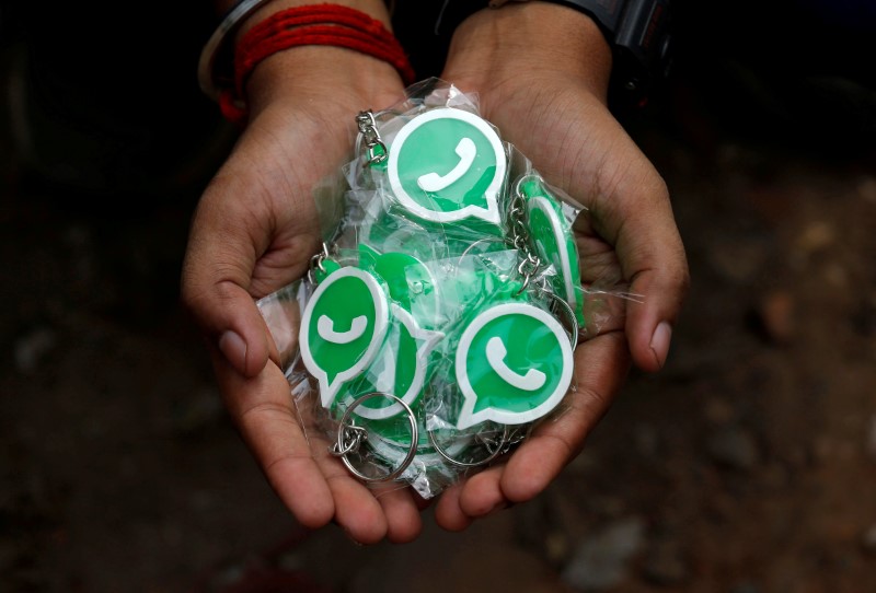 FILE PHOTO: WhatsApp-Reliance Jio representatives perform in a street play during a drive by